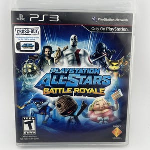 May include: A PlayStation 3 game case for PlayStation All-Stars Battle Royale featuring various video game characters on a blue background. The cover includes the PS3 logo, ESRB Teen rating, and a Cross-Buy label for the PS Vita system.