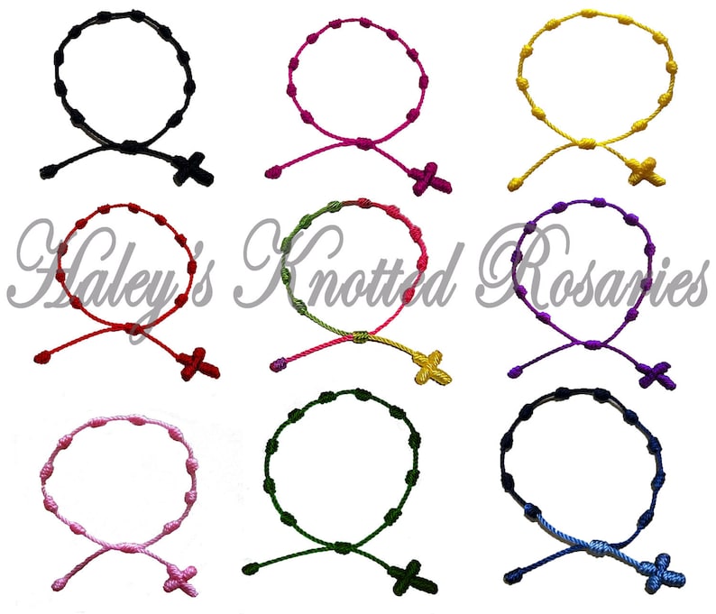 May include: Assortment of ten knotted rosary bracelets in various colors, including black, red, yellow, green, purple, pink, and blue. Each bracelet features a small cross charm.