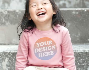 Mockup Rabbit Skins 3302 Toddler Youth Long Sleeve T-shirt in Pink with Girl model front view