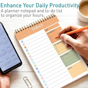 May include: A planner notepad with a spiral binding, featuring a to-do list and the word "TODAY" at the top. The notepad has sections for date, top priorities, and notes. A person is writing on the notepad with an orange pen. A smartphone and a paperclip are also visible.