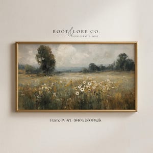 May include: A framed landscape painting featuring a field of wildflowers in shades of yellow and white, with trees and a cloudy sky in the background. The artwork is in a gold frame and includes the text "ROOT & LORE CO." and "Frame TV Art - 3840 x 2160 Pixels."
