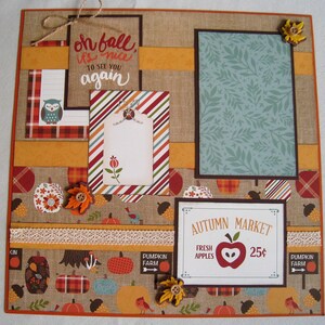 May include: A scrapbook page with a fall theme. It features a burlap background with orange, brown, and red accents. Decorative elements include pumpkins, leaves, and the text "Autumn Market Fresh Apples 25¢". The text "Oh fall, it's nice to see you again" is also present.