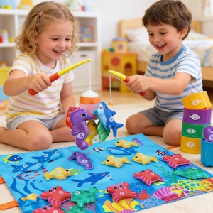 May include: Children playing a fishing game with colorful toy fish and fishing rods. The game includes a blue mat with an underwater scene, various fish toys, and stacking containers. The children are smiling and engaged in the activity.