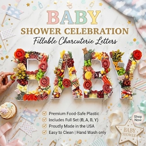 May include: A baby shower charcuterie display spells out "BABY" with fillable letters. The letters are filled with various foods, including olives, grapes, and salami roses. The image includes text that says "Baby Shower Celebration" and "Shop Now".