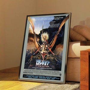 May include: Framed movie poster for "Heavy Metal," a science fiction film. The artwork depicts a winged creature with a female rider, set against a futuristic cityscape. The poster includes the film's title and credits, with text that reads "A step beyond science fiction."