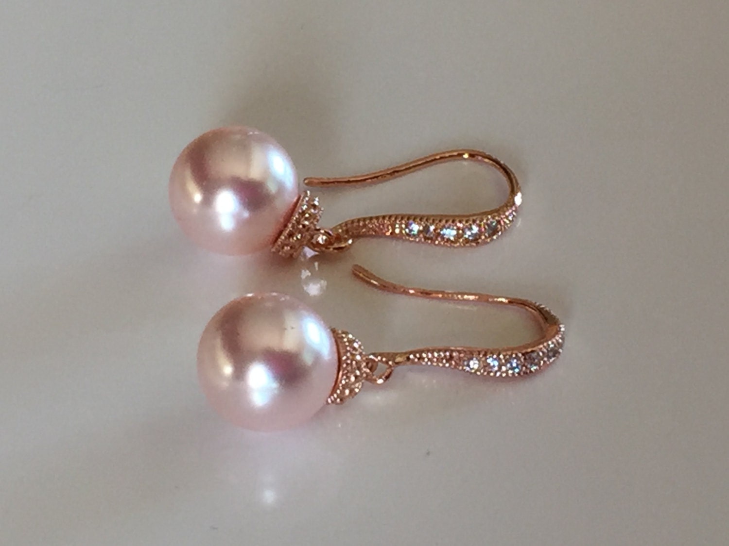 Pink pearl earrings on rose gold rhinestone crystal ear Etsy