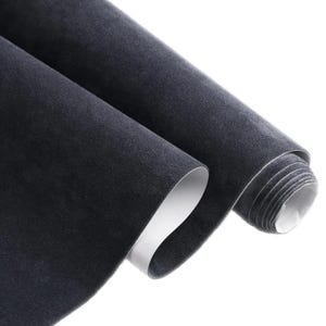 May include: Two rolls of dark gray, textured fabric with a white backing are displayed. The fabric is rolled up, revealing the white backing, and the other roll is partially unrolled.