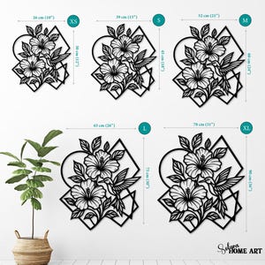 May include: Black metal wall art featuring a floral design with hibiscus flowers and a hummingbird. Available in XS (10" x 12") to XL (31" x 36") sizes. The art includes geometric shapes and the text "Solura HOME ART".