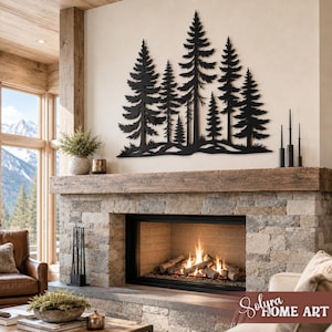 May include: A black metal wall art piece depicting a forest of pine trees. The artwork is mounted above a stone fireplace with a wooden mantel. The room has a rustic, cabin-like aesthetic, with a view of a mountain range.