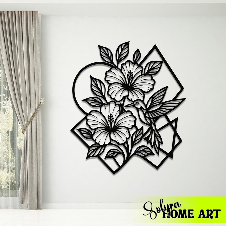 May include: Black metal wall art featuring a floral design with hibiscus flowers and a hummingbird. The artwork is set against geometric shapes and includes the text "Solyra HOME ART" in a neon green rectangle.