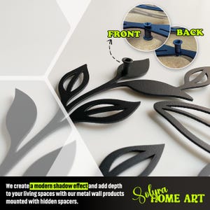 May include: Black metal leaf wall art with a modern shadow effect. The image shows the front and back of the wall art, with hidden spacers for mounting. The text reads: "We create a modern shadow effect and add depth to your living spaces with our metal wall products mounted with hidden spacers."