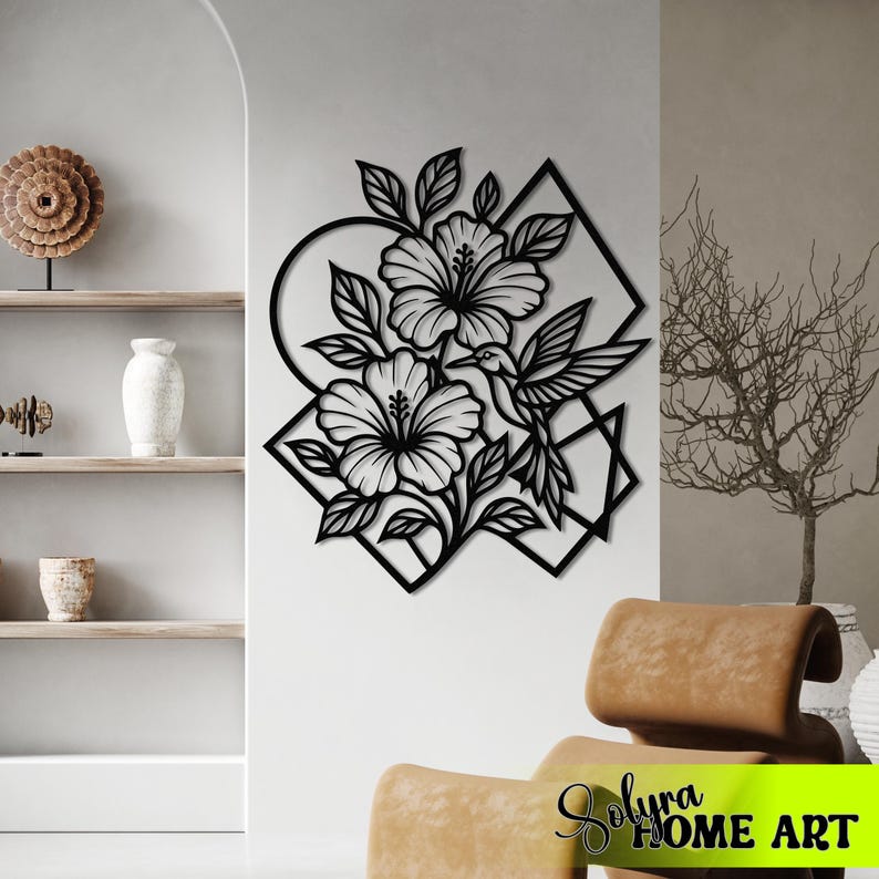 May include: Black metal wall art featuring a floral design with hibiscus flowers and a hummingbird. The artwork is set against geometric shapes, including a circle and a diamond. The piece is designed for home decor.