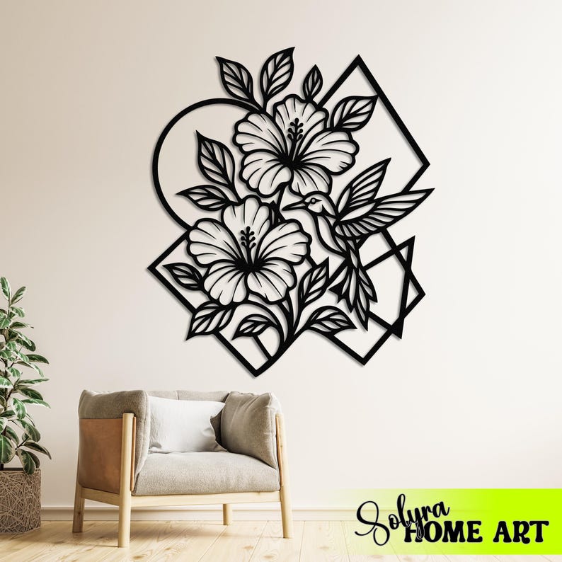 May include: Black metal wall art featuring hibiscus flowers and a hummingbird within geometric shapes. The design includes a circle, square, and triangle. The text "Solyra HOME ART" is visible in the bottom right corner.