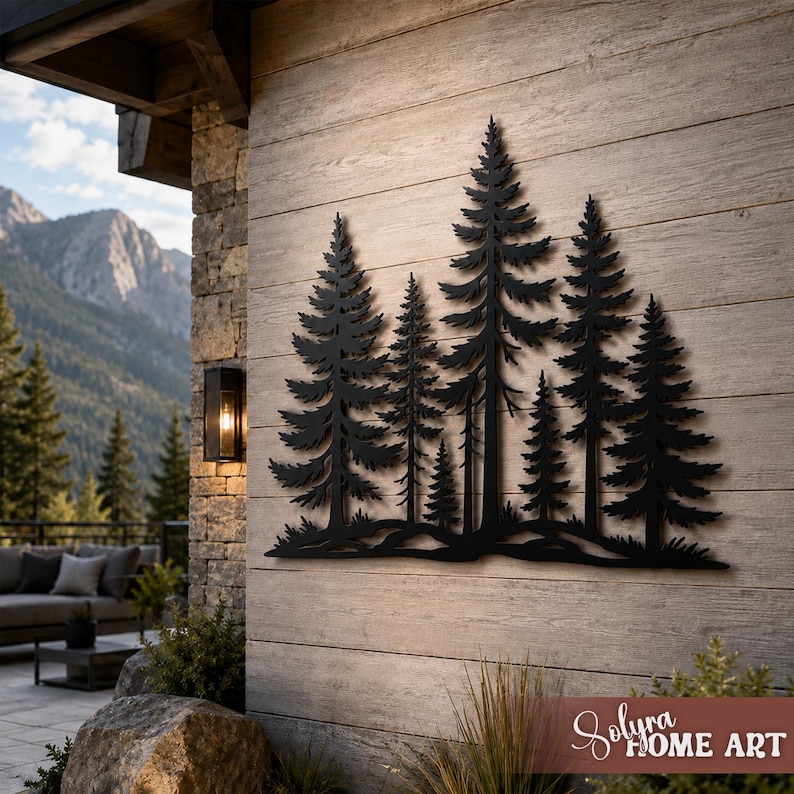 May include: Black metal wall art depicting a forest of pine trees. The artwork is mounted on a light brown wooden wall. The scene includes a mountain range in the background and a patio area.