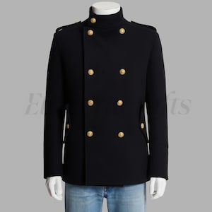 May include: A black double-breasted coat with gold-colored buttons. The coat has a high collar and epaulettes on the shoulders. The sleeves have buttoned cuffs. The coat is displayed on a mannequin.
