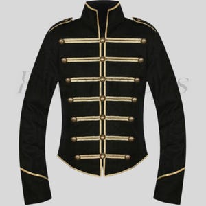 May include: Black military-style jacket with gold trim and buttons. The jacket features a high collar and gold horizontal stripes across the chest. The sleeves are long and fitted, with gold trim at the cuffs. The jacket has a tailored fit.