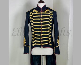 May include: Black military-style jacket with gold trim and buttons. The jacket features a high collar and a tailcoat design. Gold embroidery accents the sleeves. The jacket is displayed on a mannequin.