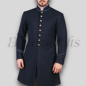 May include: A navy blue coat with a mandarin collar and gold buttons. The coat has light blue trim on the collar, cuffs, and along the button line. The coat is a long, tailored style.