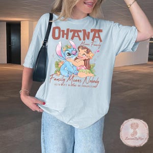 May include: A white ceramic mug with a black handle and the text "But First, Coffee" in a bold, black font. The mug is set against a neutral background, highlighting its simple design.