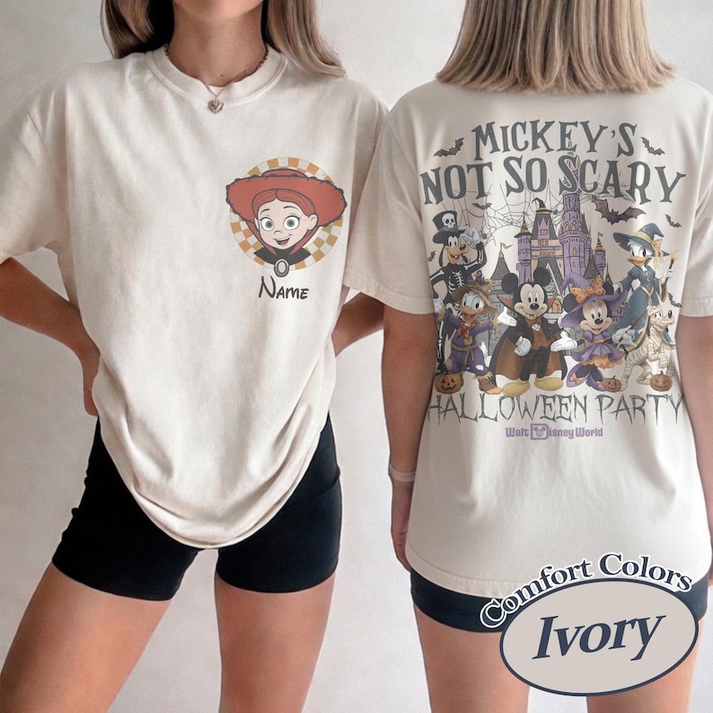 May include: Ivory-colored t-shirts with Disney Halloween graphics. One shirt features a cartoon character with the name field, and the other displays "Mickey's Not So Scary Halloween Party" with Disney characters and a castle.