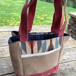 May include: A set of three ceramic mugs with a speckled, matte finish. Each mug features a different color: light blue, cream, and gray. The mugs have a simple, modern design and a comfortable handle.