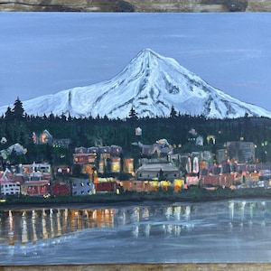 May include: A painting of a snow-capped mountain with a town at the base. The town is lit up with lights, and the mountain is reflected in the water in the foreground.