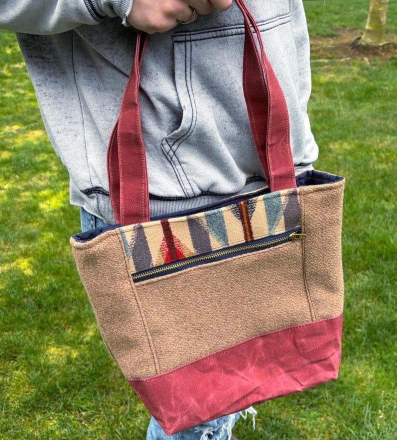 May include: A set of three ceramic mugs with a speckled, matte finish. The mugs are in shades of cream, light brown, and dark brown. Each mug has a simple, minimalist design, perfect for coffee or tea.