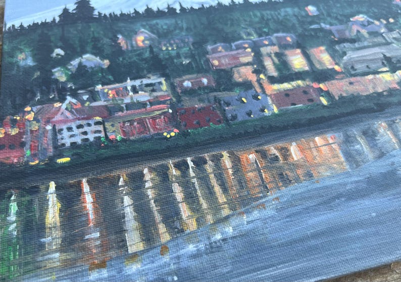 May include: A painting of a city skyline at night with a reflection of the city lights in the water below. The buildings are painted in shades of brown, red, and yellow, and the water is a dark blue.