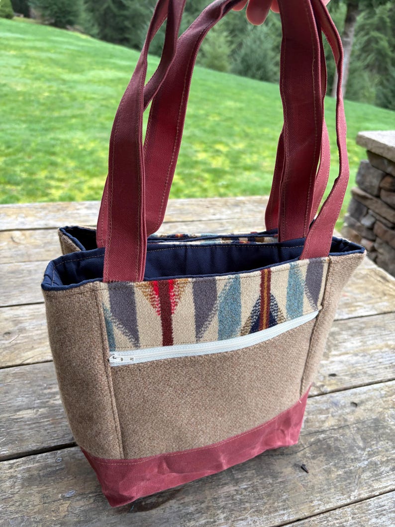 May include: A set of three ceramic mugs with a speckled, matte finish. Each mug features a different color: light blue, cream, and gray. The mugs have a simple, modern design and a comfortable handle.