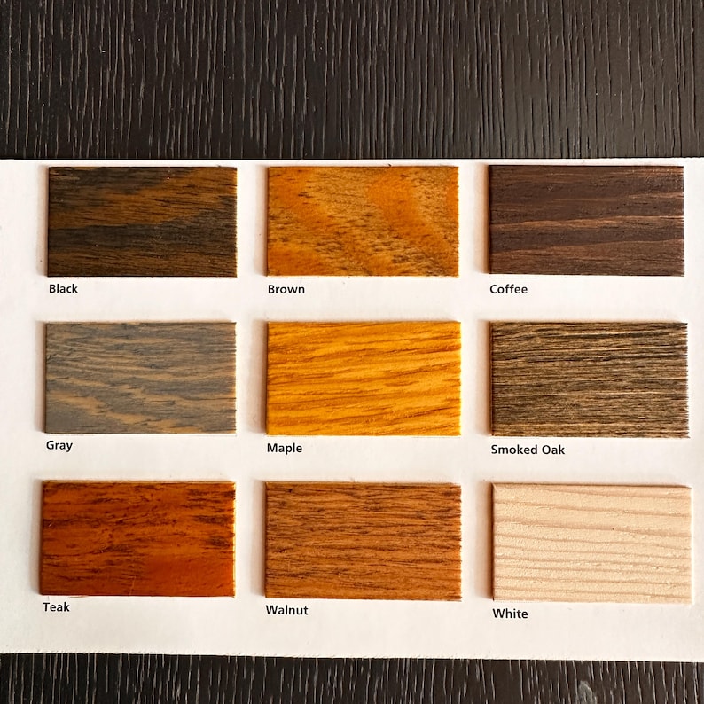 May include: A color swatch chart featuring nine wood stain samples. The samples include Black, Brown, Coffee, Gray, Maple, Smoked Oak, Teak, Walnut, and White. Each sample is labeled with its respective color name.
