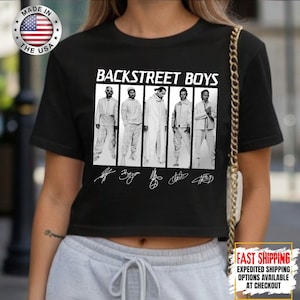 May include: Black crop top featuring the text "BACKSTREET BOYS" above a black and white image of the band members. The shirt also includes the band members' signatures. A "MADE IN THE USA" logo is visible.