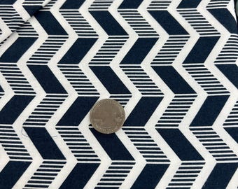 May include: White fabric with a navy blue geometric pattern of repeating chevron shapes. The pattern is made up of thin white stripes on a navy blue background.