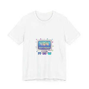 May include: White t-shirt featuring a retro computer graphic with the text "404 NOT FOUND" in a blue and green color scheme. The design includes a computer monitor, floppy disk, and other computer-related elements.