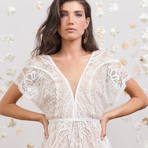 Stunning bohemian wedding dress with deep v neck line, open back, short kimono sleeves & breathtaking hem handmade from stunning floral lace