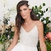 Simple and effortlessly stunning bohemian wedding dress. Delicate wedding dress with lace top, open back, wrap skirt, a slit and a train 