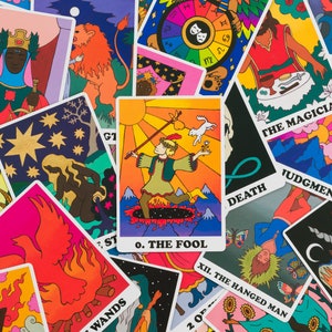 Tossed cards from the Rainbow Heart Tarot with The Fool card displayed prominently in the middle- cards feature a retro groovy psychedelic illustration style