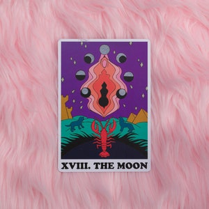 The Moon card from the Rainbow Heart Tarot against pink faux fur background