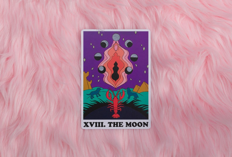The Moon card from the Rainbow Heart Tarot against pink faux fur background