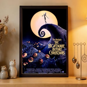 May include: Framed movie poster for Tim Burton's "The Nightmare Before Christmas." The artwork features Jack Skellington on a hill with a spiral, a large full moon, and carved pumpkins. The title is in a stylized font.