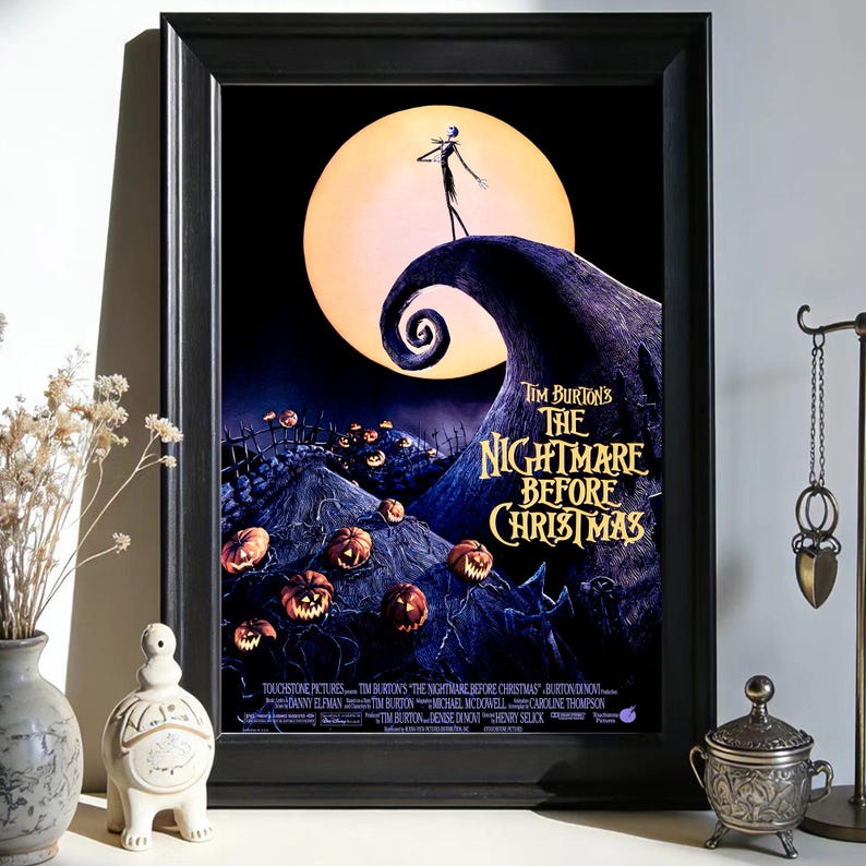 May include: Framed poster featuring the movie "The Nightmare Before Christmas." The artwork depicts Jack Skellington on a hill with a spiral, a full moon, and carved pumpkins. The title is in gold lettering against a dark background.