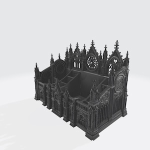 Puede incluir: Un organizador de escritorio de estilo g&oacute;tico gris oscuro con m&uacute;ltiples compartimentos. El organizador presenta intrincados detalles arquitect&oacute;nicos, incluyendo arcos apuntados, agujas y rosetones. El dise&ntilde;o recuerda a una catedral o iglesia.