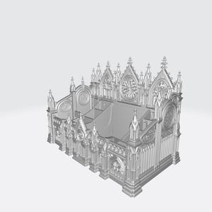 Puede incluir: Modelo gris impreso en 3D de una catedral g&oacute;tica. Presenta arcos apuntados, rosetones y pin&aacute;culos decorativos. El modelo tiene una base rectangular y m&uacute;ltiples niveles, mostrando intrincados detalles arquitect&oacute;nicos.
