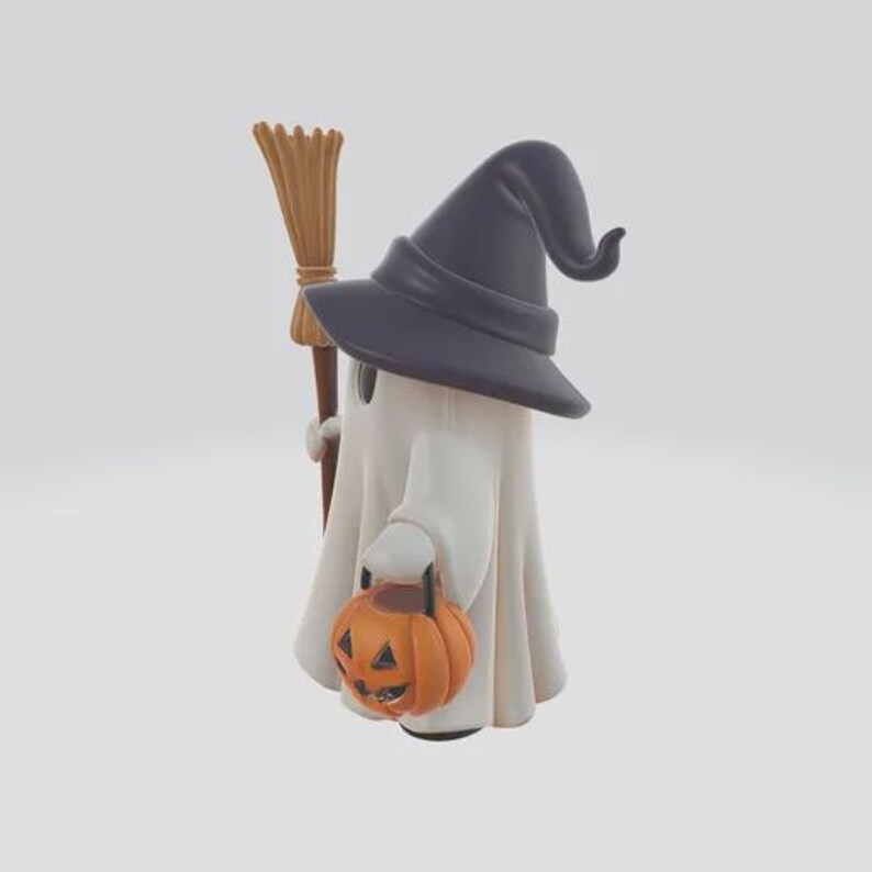 May include: A white ghost figure wearing a dark purple witch hat, holding a small orange pumpkin bucket and a brown broom. The ghost has black eyes and a white sheet-like body, perfect for Halloween decorations.