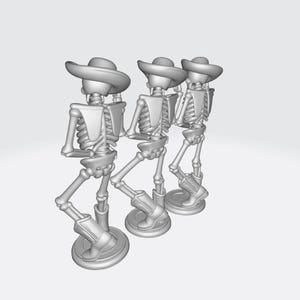 May include: Three gray skeleton figurines wearing cowboy hats and boots. The skeletons are posed in a line, with one leg raised as if dancing. Each figure is mounted on a circular base.