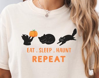 Camiseta "Coma, Durma, Assombre, Repita", Camiseta divertida com estampa de gato preto em cores vibrantes, Presente perfeito para amantes de gatos no Halloween