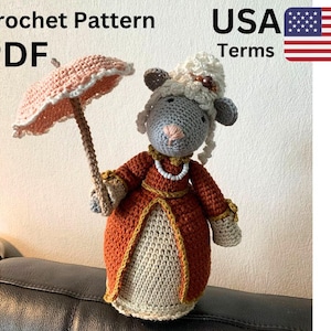 May include: A crocheted doll of a sheep wearing a red and gold dress, holding a pink parasol. The doll has a gray face, white hair, and a pearl necklace. The words "Crochet Pattern PDF" and "USA Terms" are in the image.