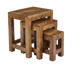 May include: A set of three nested tables crafted from brown wood with a visible grain pattern. Each table features a square top and four sturdy legs, designed to slide neatly underneath one another to save space when not in use.