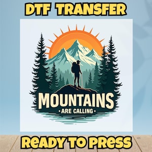 May include: DTF TRANSFER graphic featuring a hiker with a backpack and walking stick standing on a mountain, with the text "MOUNTAINS ARE CALLING." The design includes a sun, mountains, and trees. The words "READY TO PRESS" are also included.