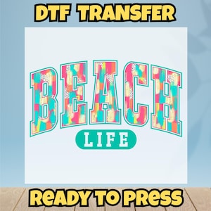 May include: A DTF transfer design with the words "BEACH LIFE" in a colorful, block letter style. The letters are filled with a mix of pink, blue, and yellow brushstrokes and black polka dots. The words "DTF TRANSFER" and "READY TO PRESS" are also included.