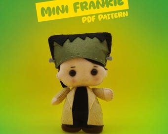 May include: A handmade felt doll of Frankenstein's monster. The doll has a green hat, black hair, and a tan coat. The text "MINI FRANKIE PDF PATTERN" is in a yellow banner above the doll.